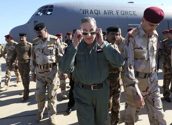 In this March 9 file photo, Iraqi Defence Minister Khaled Al Obeidi (centre) arrives at a military base outside Tikrit, 130 kilometres  north of Baghdad, Iraq (AP photo)