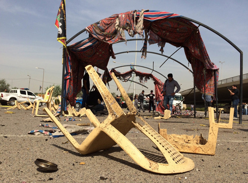 Iraqi security forces gather at the site of a bomb attack in Baghdad, Iraq, on Sunday (AP photo)
