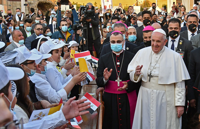 Pope Francis (right) is greeted by children upon his arrival at Baghdad's Saint Joseph Cathedral on the second day of the first papal visit to Iraq on Friday (AFP photo)