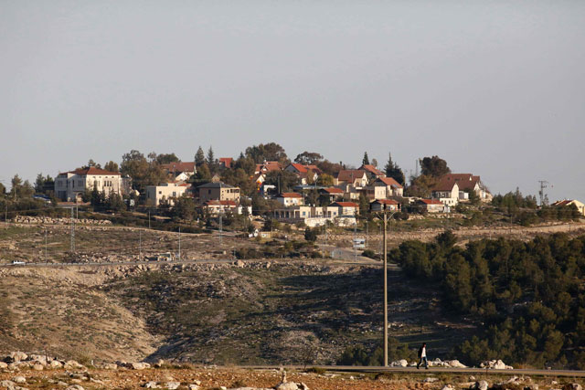 A photo taken on Tuesday, from the Palestinian village Al Dayrat in the southern West Bank, shows in the background the Israeli settlement unit of Karmel (AFP photo)