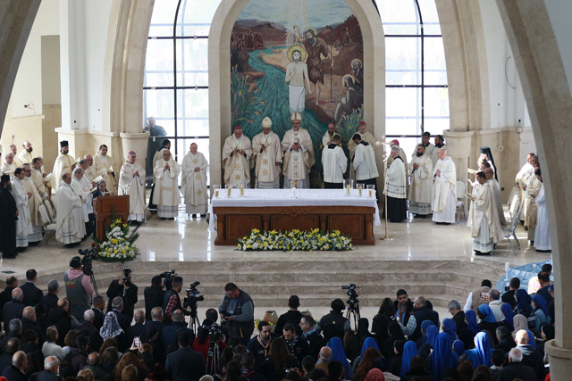 Pierbattista Pizzaballa (centre), the Latin Patriarch of Jerusalem, leads a mass at the Church of Saint John the Baptist, near the Baptism Site, where Jesus is believed by Christians to have been baptised by the saint, in the Jordan River Valley, some 60km southwest of Amman, on Friday (AFP photo)