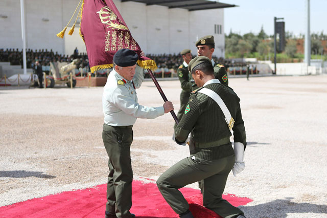 His Majesty King Abdullah, the Supreme Commander of the Jordan Armed Forces-Arab Army, hands in the Supreme Commander’s Colours to the Prince Muhammad Mechanised Battalion/9 in Amman on Tuesday (Photo courtesy of Royal Court)