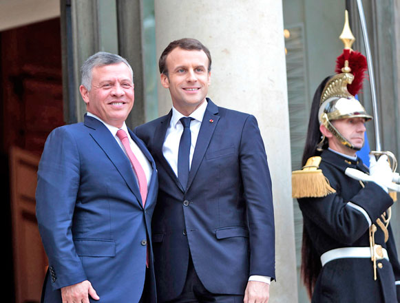 His Majesty King Abdullah is greeted by French President  Emmanuel Macron ahead of their meeting in Paris on Tuesday (Photo courtesy of Royal Court)
