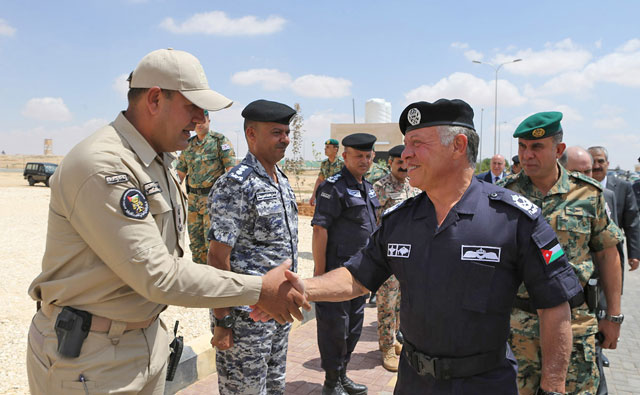 His Majesty is greeted by top police officers as he arrives to attend a drill by a newly set up unit to protect foreign investors and their assets (Photo courtesy of Royal Court)   