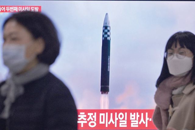 People walk past a television showing a news broadcast with file footage of a North Korean missile test, at a railway station in Seoul, on Saturday (AFP photo)