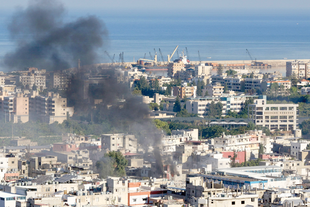 Smoke billows during clashes in the Ain Al Helweh camp for Palestinian refugees, in Lebanon's southern coastal city of Sidon, on Friday (AFP photo)
