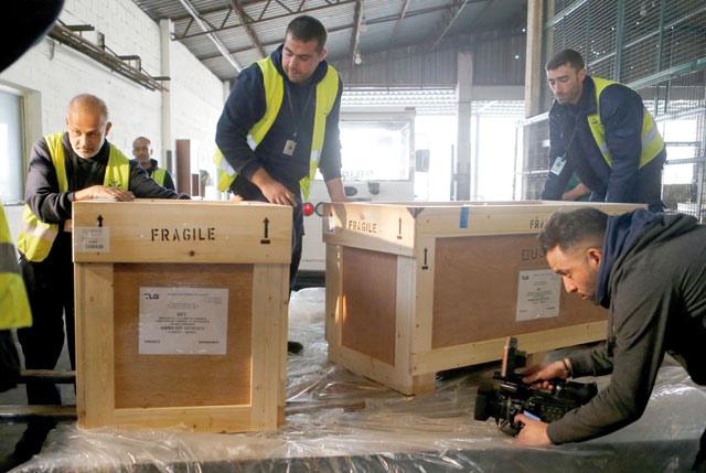 Workers unload boxes of artefacts at Beirut’s International Airport in Beirut, Lebanon, on Friday (Reuters photo)