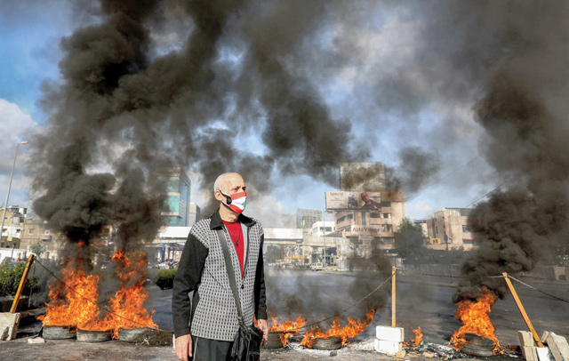 Black smoke billowed up from overturned rubbish dumpsters and tyres set ablaze by protesters at various entrances to Beirut from the early morning (AFP photo)