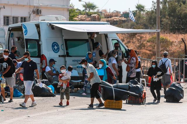 Migrants enter a new temporary site in Lesbos on September 17 as police launched an operation to rehouse thousands of them who have been sleeping rough after their camp was destroyed by fire last week (AFP photo)
