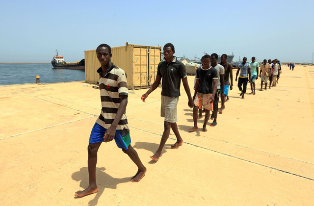 Illegal migrants from Africa, walk at a port in Tripoli prior to being taken to a naval base after they were rescued by Libyan coastguards in the Mediterranean Sea off the Libyan coast, on Monday (AFP photo)
