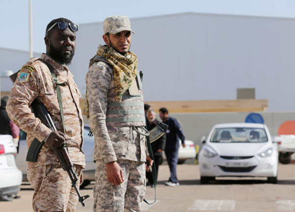 Security officers stand next to the administration building at the industrial zone at the oil port of Brega, Libya, on January 12 (Reuters photo)