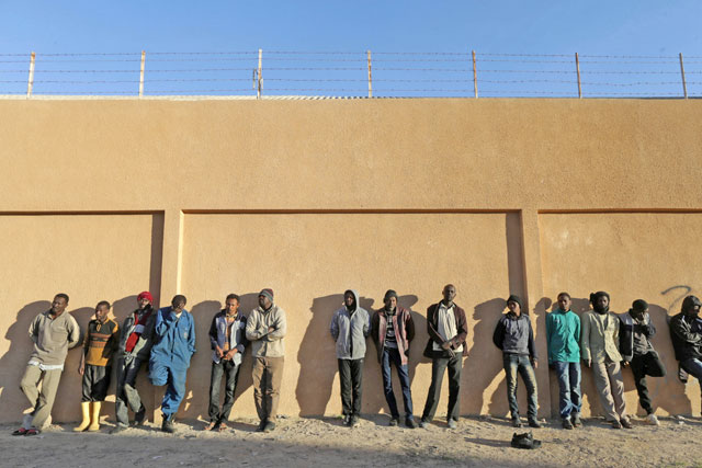 Migrants stand in a detention centre run by the interior ministry of Libya's eastern-based government in Benghazi, Libya, on Wednesday (Reuters photo)