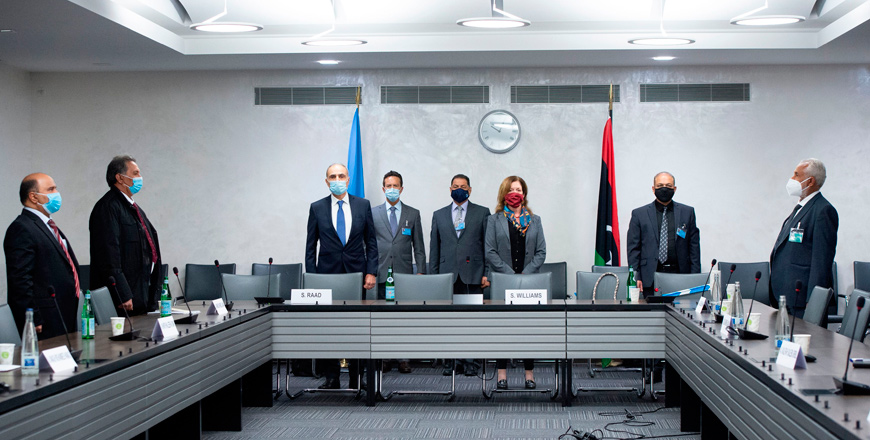 This handout photo released on Monday, by the United Nations Office at Geneva, shows Deputy Special Representative of the UN Secretary General for Political Affairs in Libya Stephanie Williams (3rd right) and representatives wearing protective face masks, standing during the Libyan national anthem at the beginning of talks between the rival factions in the Libya conflict, as they resume in Geneva (AFP photo)