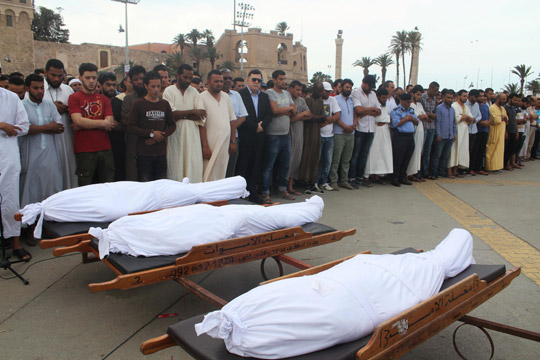 Prime Minister of Libya's Government of National Accord  Fayez Sarraj (in glasses) and people pray next to the dead bodies of members of forces loyal to the UN-backed government, in Tripoli, Libya, on Saturday (Reuters photo)