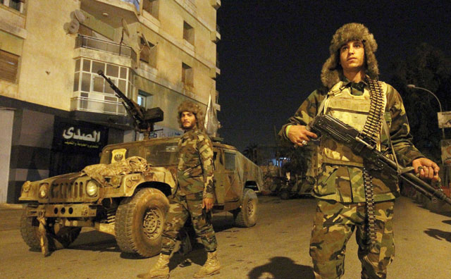 Members of the self-styled Libyan National Army, loyal to the country's east strongman Khalifa Haftar, patrol the roads leading into the eastern city of Benghazi on Wednesday (AFP photo)