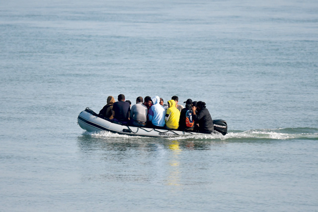 In this photo taken on September 14, 2020 migrants travel by inflatable boat as they reach the shore near Deal on the southeast coast of England after crossing the Straits of Dover from France (AFP photo)
