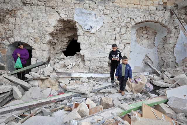 Children stand on the rubble of a house that was demolished during an Israeli raid in the Old City of Nablus on Friday (AFP photo)