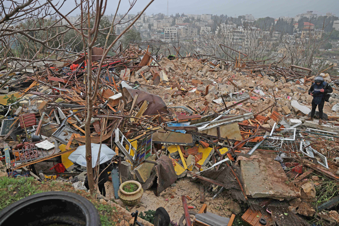 In this file photo taken on January 19, a man walks on the ruins of a Palestinian house demolished by Israeli forces, in the flashpoint occupied East Jerusalem neighbourhood of Sheikh Jarrah (AFP photo)