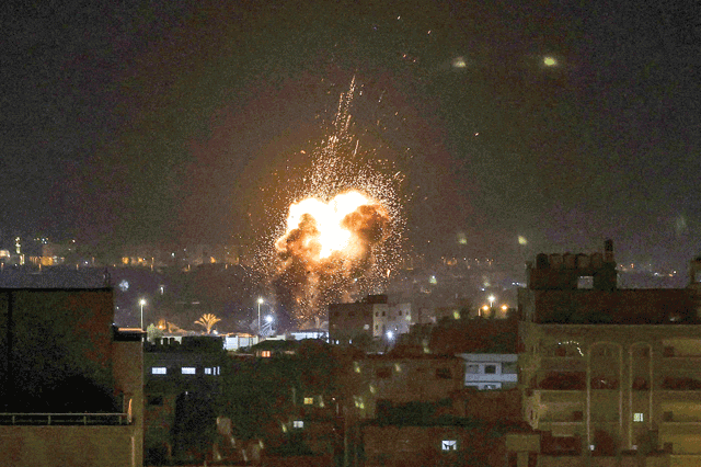 Fire and smoke rise above buildings in Gaza City as Israel launched air strikes on the Palestinian enclave early on Friday (AFP photo)