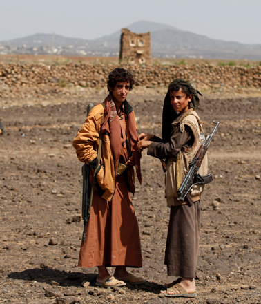 Armed boys stand at the site of a pro-Houthi tribal gathering in a rural area near Sanaa, Yemen, on Thursday (Reuters photo)