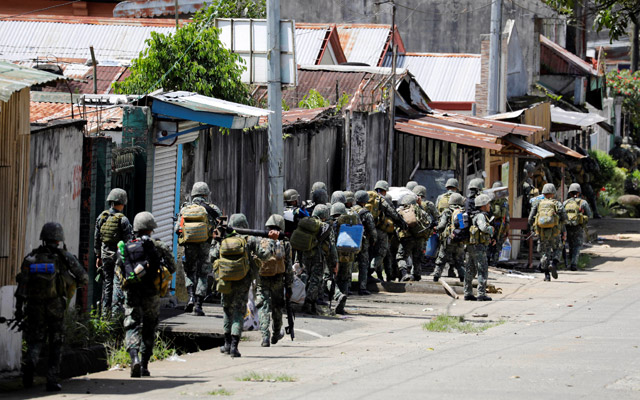 Philippine marines advance their positions as more soldiers reinforce to fight the Maute group in Marawi City, in southern Philippines, on Monday (Reuters photo)