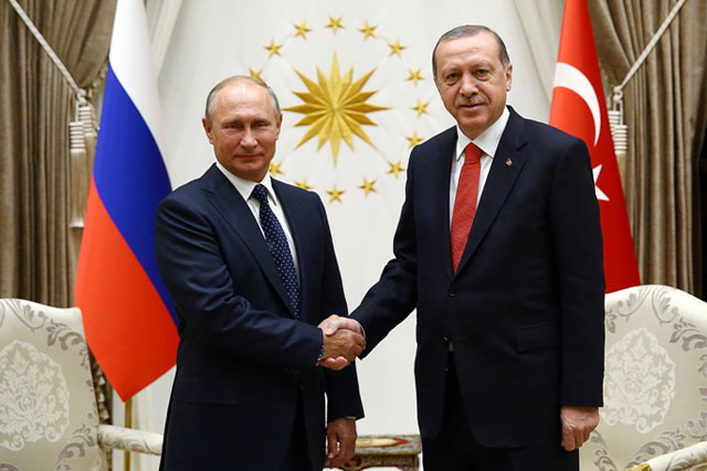 This handout photo released by the Turkish Presidential Press Office and taken on Thursday shows President of Russia Vladimir Putin (left) shaking hands with Turkish President Recep Tayyip Erdogan at Presidential Complex in Ankara during an official visit (AFP photo)