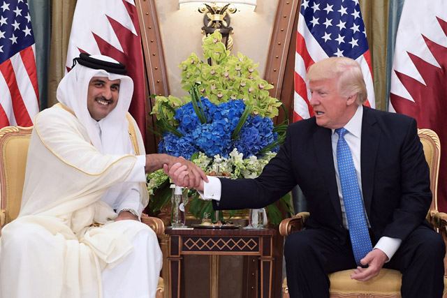  This file photo taken on May 21 shows US President Donald Trump (right) shaking hands with Qatar's Emir Sheikh Tamim Bin Hamad Al-Thani, during a bilateral meeting at a hotel in the Saudi capital Riyadh (AFP photo)