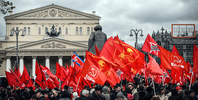 Russian Communist supporters hold flags as they attend a rally for May Day in front of Bolshoi Theatre in Moscow on Monday (AFP photo)
