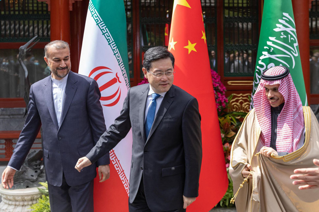This handout photo released by the Saudi Press Agency shows Iran's Foreign Minister Hossein Amir-Abdollahian walking alongside Saudi Foreign Affairs Minister Prince Faisal Bin Farhan and Chinese Foreign Minister Qin Gang during a meeting in Beijing on Thursday (AFP photo)