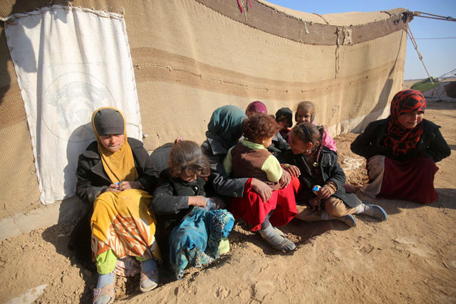 Displaced Iraqi children, from the outskirts of the city of Tal Afar, Iraq, gather outside a tent at a makeshift camp on Monday in the village of Khalif Saleh (AFP photo)