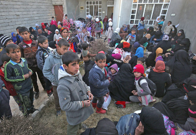 Iraqi families who fled the front line gather on Tuesday in the village of Al Buseif, south of Mosul, during an offensive by Iraqi forces to retake the western side of the city from the Daesh group (AFP photo)