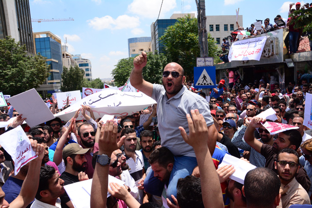 Activists take part of a rally near the Professional Associations Compound in Amman to protest against the amended Income Tax Law on Wednesday (Photo by Amjad Ghsoun)  