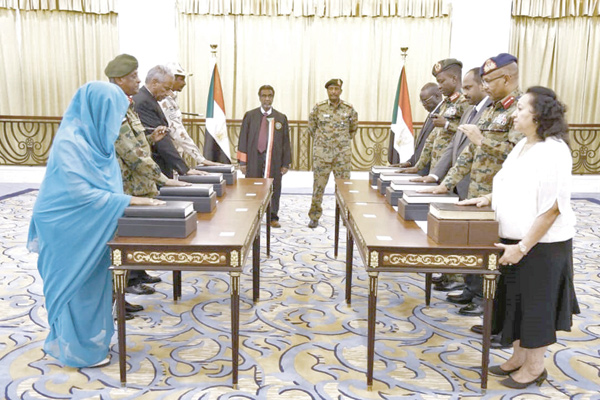 This photo released by Sudan's presidential palace shows General Abdel Fattah Al Burhan (centre-right), the head of Sudan's ruling military council, standing during a swearing in of the new sovereign council, in Khartoum, on Wednesday (AFP photo)