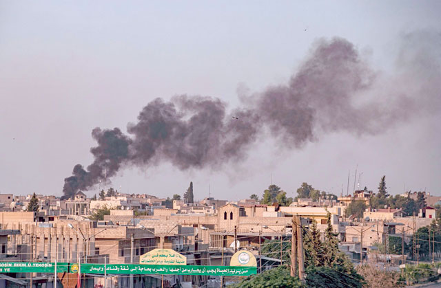 Smoke billows following Turkish bombardment in the northeastern town of Ras Al Ain in Syria's Hasakeh province along the Turkish border on Wednesday (AFP photo)