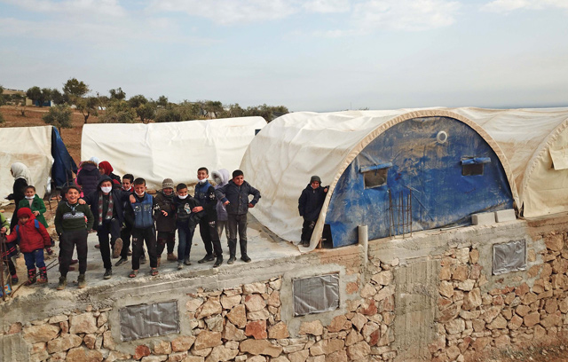 Syrian schoolchildren are pictured outside a makeshift school set up by locals in the village of Ma'arin on the outskirts of Azaz in the rebel-controlled northern countryside of Syria's Aleppo province, on Tuesday (AFP photo)
