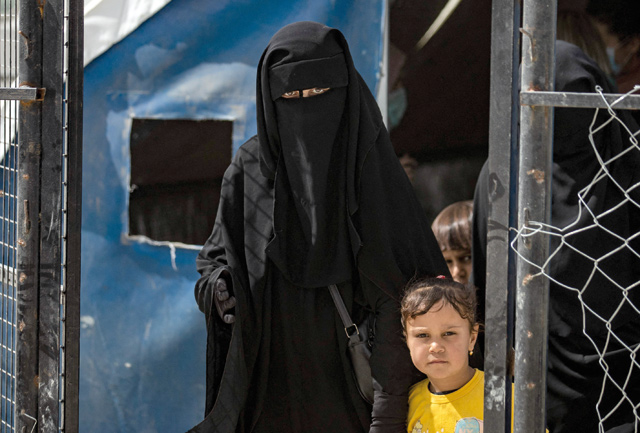 A woman and children are pictured at the Kurdish-run al-Hol camp which holds suspected relatives of Daesh terror group fighters, in Hasakeh governorate of northeastern Syria, on Wednesday (AFP photo)