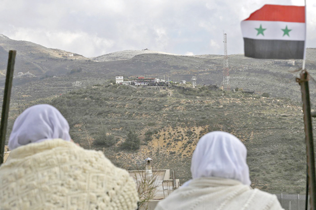 Druze women residing in Israeli occupied Golan Heights look to other side of border in this recent photo (AFP file photo)