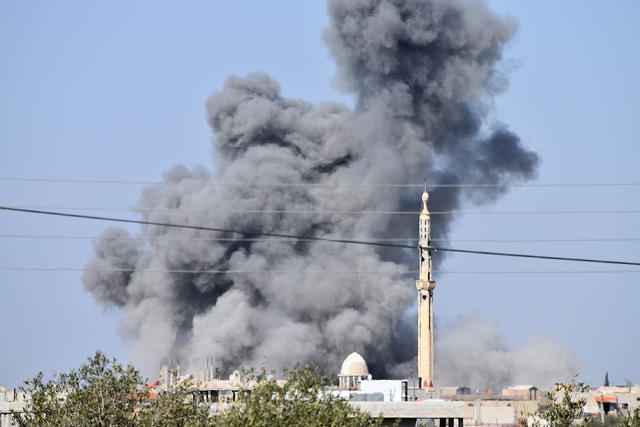 Smoke rises after the warplanes belonging to the Assad Regime Forces carried out air strikes on opposition-controlled Busra Al Harir town of Daraa, Syria, on Weduesday (Anadolu photo)