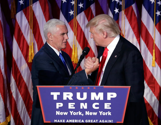 US President-elect Donald Trump shakes hands with Vice President-elect Mike Pence as he gives his acceptance speech during his election night rally on Wednesday in New York  (AP photo by John Locher)