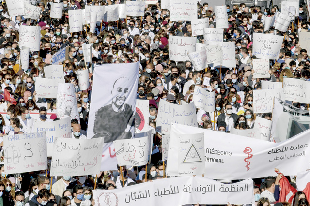 Tunisian doctors chant slogans demanding the resignation of the health minister, in the capital Tunis, on Tuesday (AFP photo)