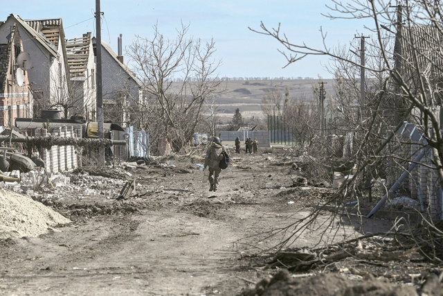An Ukranian serviceman walks in the village of Mala Rogan, east of Kharkiv, after the Ukranian troops retaking the village on Monday (AFP photo)
