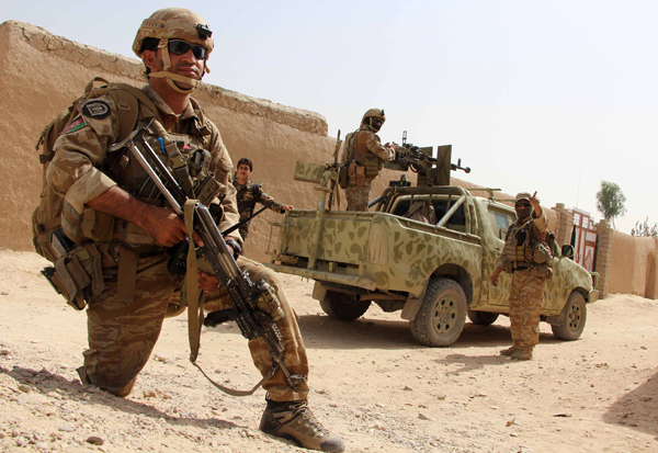In this photograph taken on Monday, Afghan National Army commandos take position during a military operation in Helmand province (AFP photo)