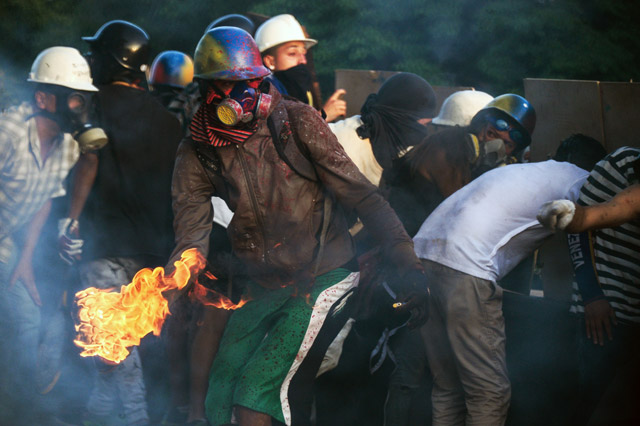 Venezuelan opposition activists clash with the riot police during a rally against the government of President Nicolas Maduro in Caracas on Friday (AFP photo)