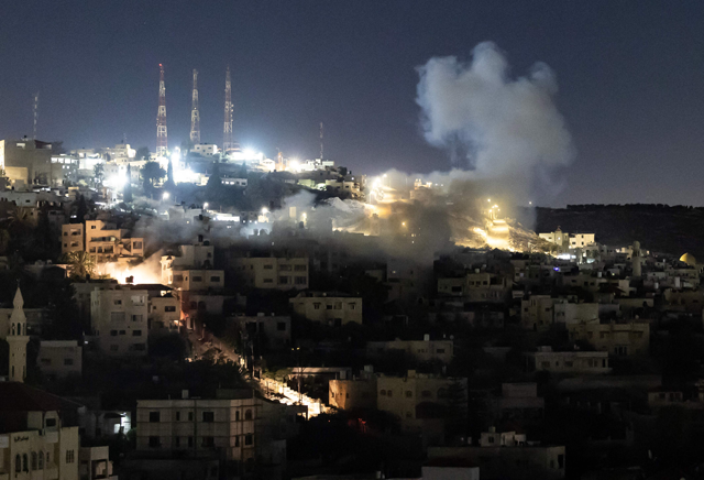 Smoke raises during an Israeli army raid in the occupied West Bank Jenin refugee camp overnight on Thursday (AFP photo)
