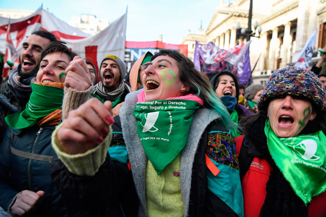 Pro-choice activists wait outside the Argentine congress in Buenos Aires, on Thursday, before the approval of a bill to legalise abortion (AFP photo)