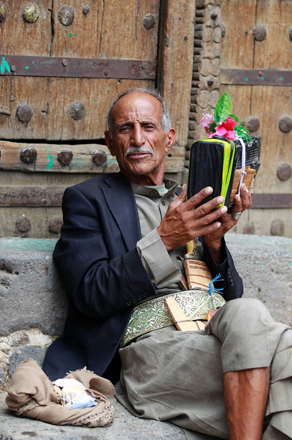 Yemeni man sits listening to a radio at a popular market in the old city of the capital Sanaa, on Sunday (AFP photo)