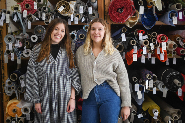 This photo shows (Left to right) Rosie Scott and Hannah Silvani, co-founders of The New Craft House, a sewing workshop studio and designer deadstock fabric shop, in Hackney, East London on February 11, 2022 (AFP photo)