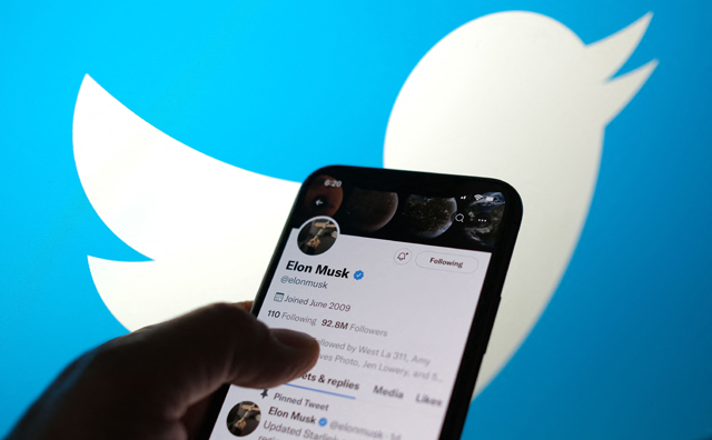 This illustration photo taken on Friday displays Elon Musk’s Twitter account with a Twitter logo in the background in Los Angeles (AFP photo)