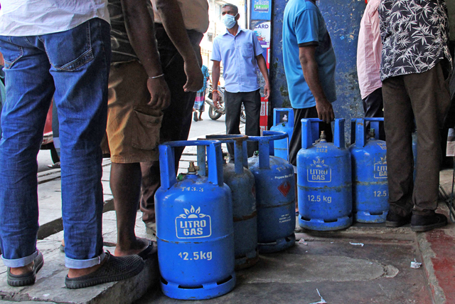People queue to buy Liquefied Petroleum Gas cylinders in Colombo on Wednesday, as shortages of essentials gripped the country following a severe shortage of foreign exchange to finance imports (AFP photo)