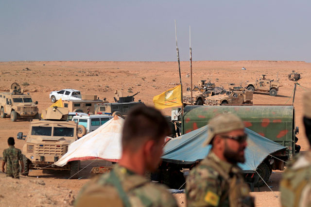 Coalition forces and members of the Syrian Democratic Forces gather at their operation room near the village of Susah in the eastern province of Deir Ezzor, near the Syrian border with Iraq, on September 14 (AFP photo)